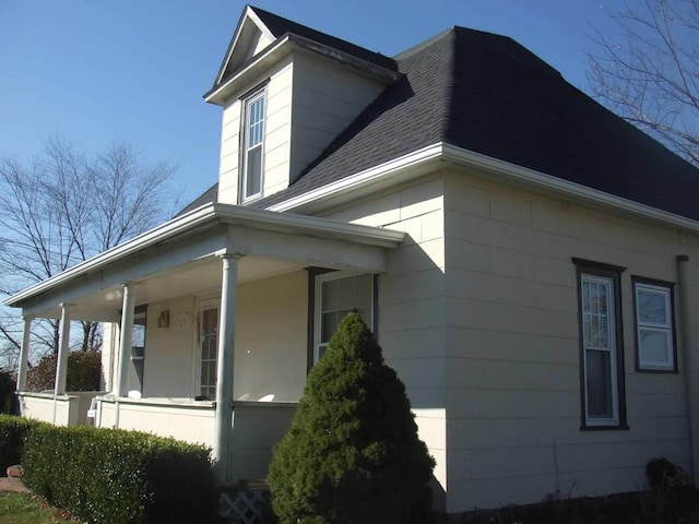 411 W W, Callao, MO 63534 - view of side of home with a porch and roof with shingles