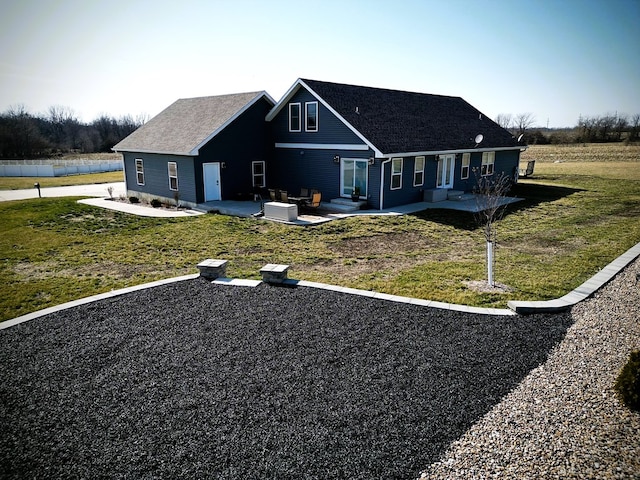 view of front of property with a patio and a front lawn