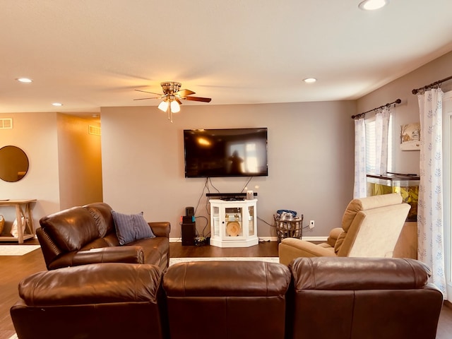 living room with hardwood / wood-style flooring and ceiling fan