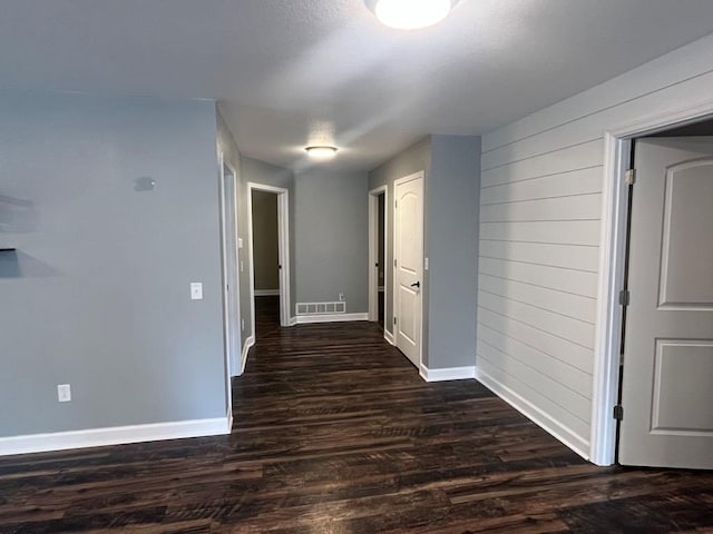 hallway with dark wood-type flooring