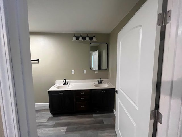 bathroom with hardwood / wood-style floors and vanity