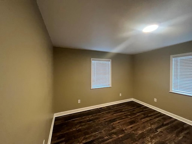 empty room with dark hardwood / wood-style floors