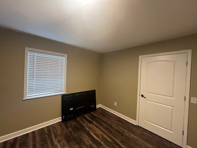 unfurnished bedroom featuring dark wood-type flooring