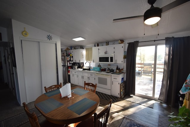 dining space with dark hardwood / wood-style floors, vaulted ceiling, ceiling fan, and sink