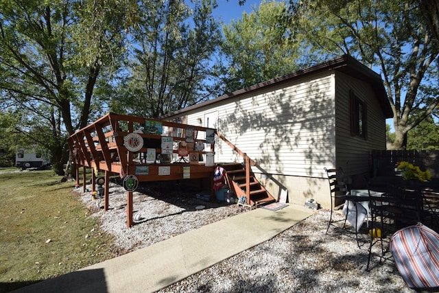 back of property featuring a wooden deck