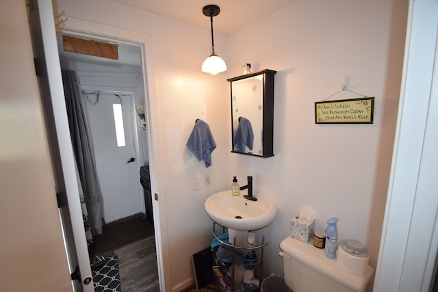 bathroom with hardwood / wood-style flooring, toilet, and sink