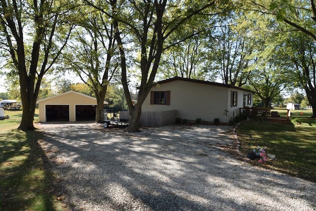 view of home's exterior featuring an outbuilding, a garage, and a deck