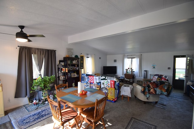 dining room featuring vaulted ceiling with beams, ceiling fan, carpet, and a textured ceiling