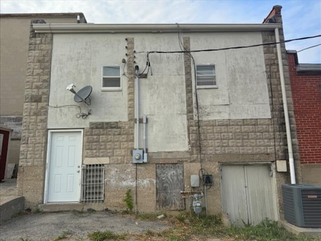 back of property featuring central AC unit