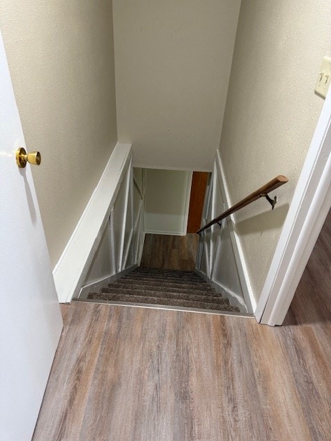 stairway featuring hardwood / wood-style flooring