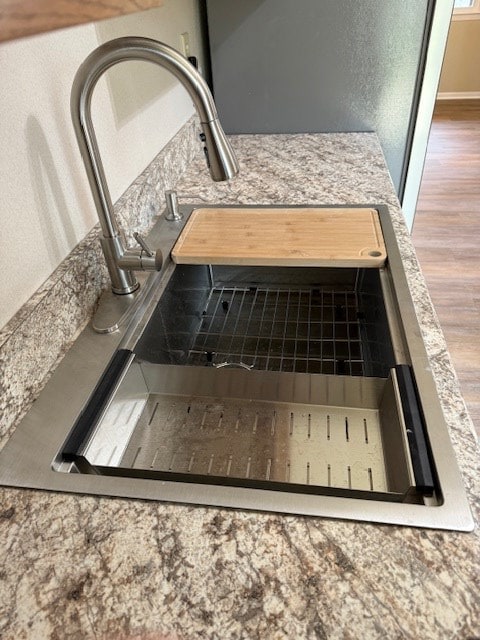 interior details featuring wood-type flooring and sink