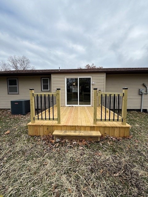 back of house with central AC and a deck