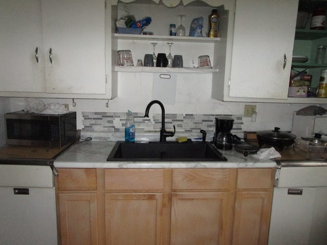 kitchen featuring open shelves, light brown cabinets, backsplash, and a sink