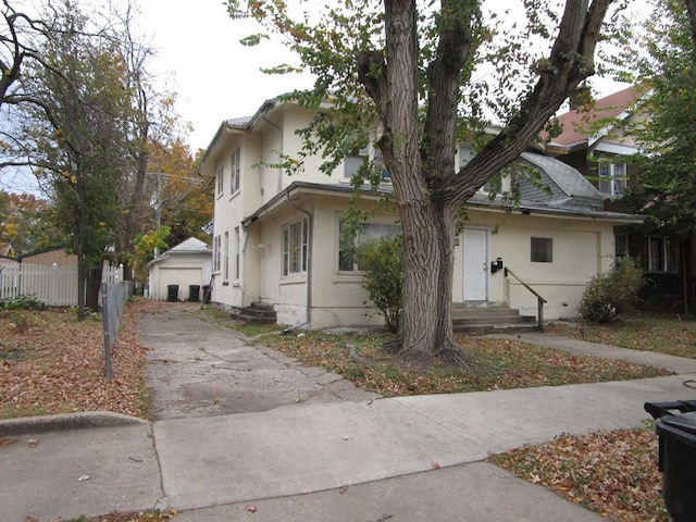 view of front of property with a garage and an outdoor structure