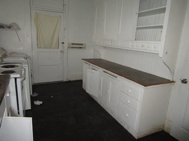 kitchen featuring white range with electric stovetop, white cabinetry, dark countertops, and open shelves