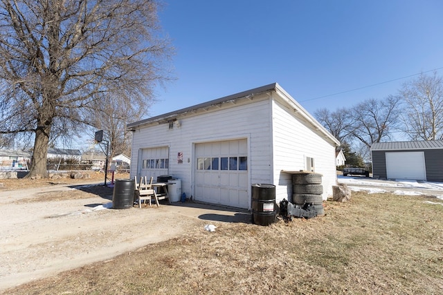 exterior space featuring a garage and an outdoor structure