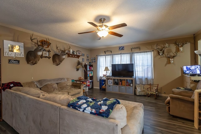 living room with dark wood-type flooring, ceiling fan, ornamental molding, and a textured ceiling