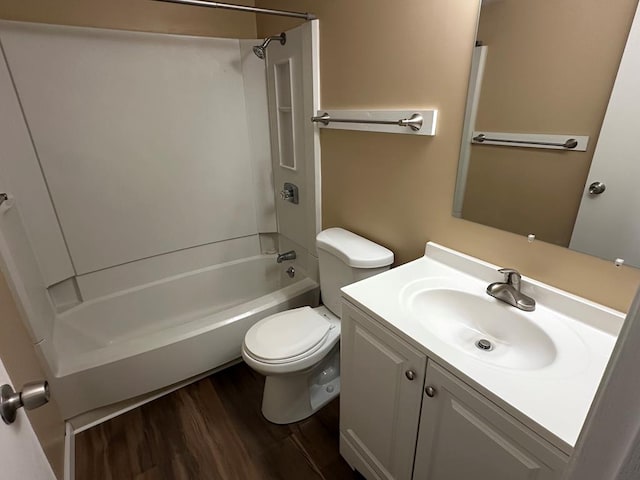 bathroom with vanity, tub / shower combination, wood finished floors, and toilet