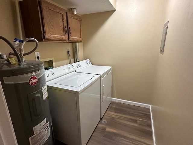 laundry room featuring baseboards, water heater, cabinet space, dark wood-style floors, and washing machine and clothes dryer