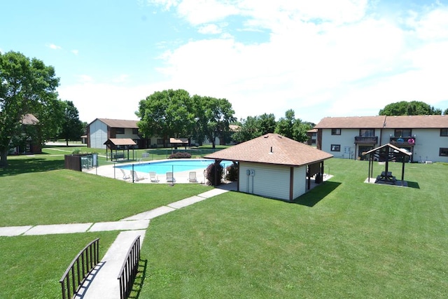 view of pool featuring a lawn