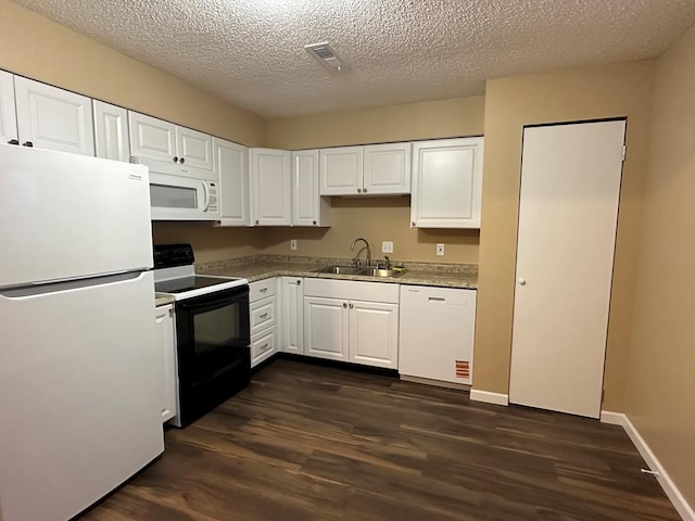 kitchen featuring white appliances, dark wood-type flooring, a sink, and white cabinetry