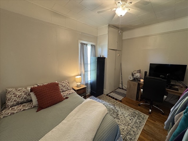 411 S Macon St, Bevier, MO 63532 - bedroom featuring wood finished floors, an office area, and ceiling fan