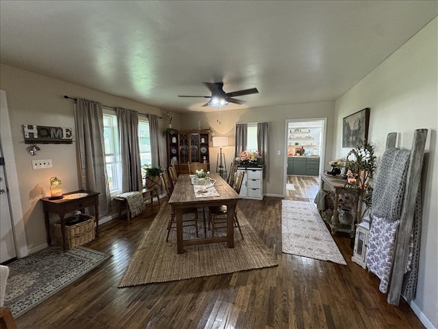 411 S Macon St, Bevier, MO 63532 - dining room featuring dark wood-style floors, baseboards, and a ceiling fan