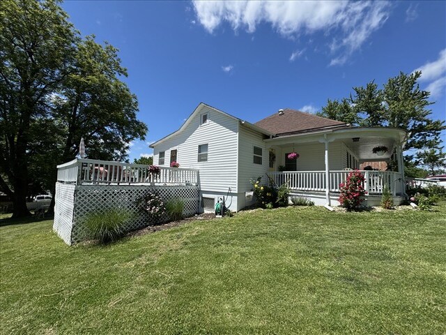 411 S Macon St, Bevier, MO 63532 - back of house with a porch, a lawn, crawl space, and a shingled roof