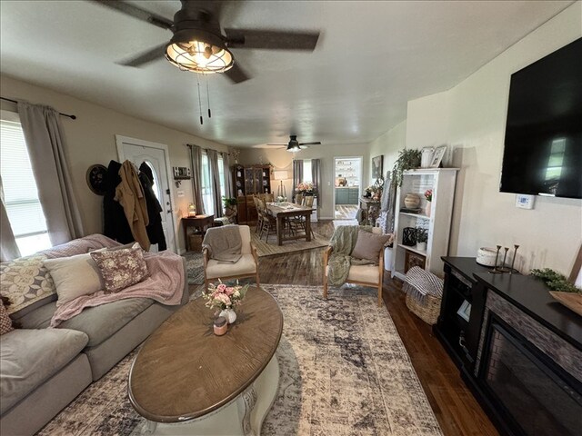 411 S Macon St, Bevier, MO 63532 - living room featuring dark wood-style flooring and ceiling fan