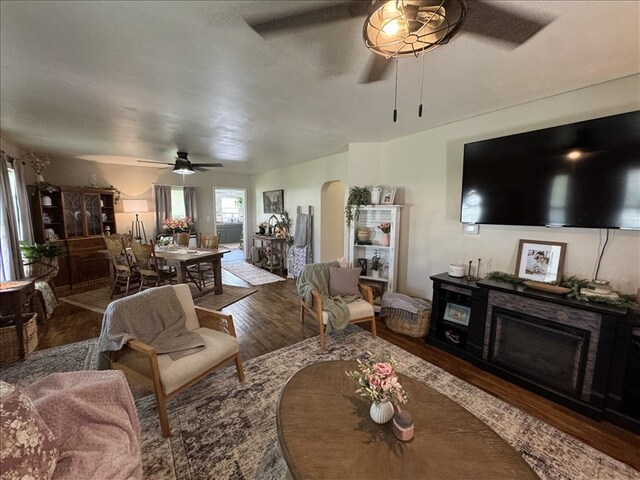 411 S Macon St, Bevier, MO 63532 - living room with ceiling fan, arched walkways, and wood finished floors