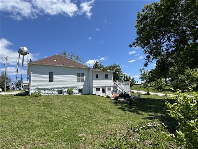 411 S Macon St, Bevier, MO 63532 - rear view of house with a yard, a shingled roof, and central AC