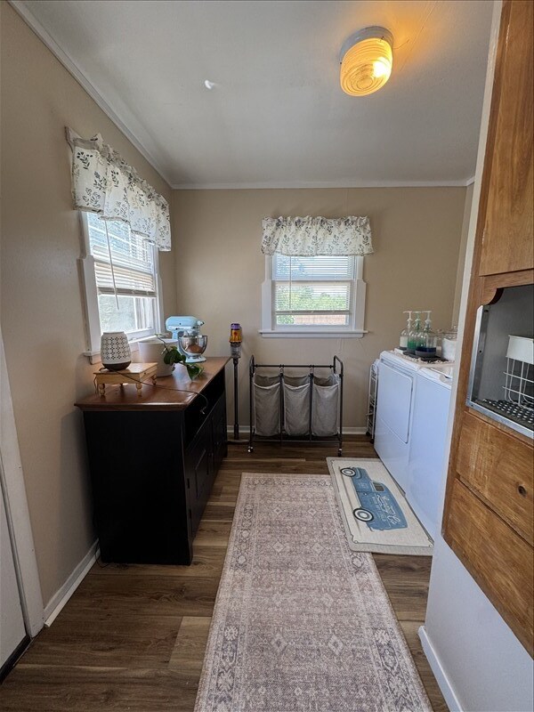 411 S Macon St, Bevier, MO 63532 - laundry room with separate washer and dryer, crown molding, wood finished floors, and plenty of natural light
