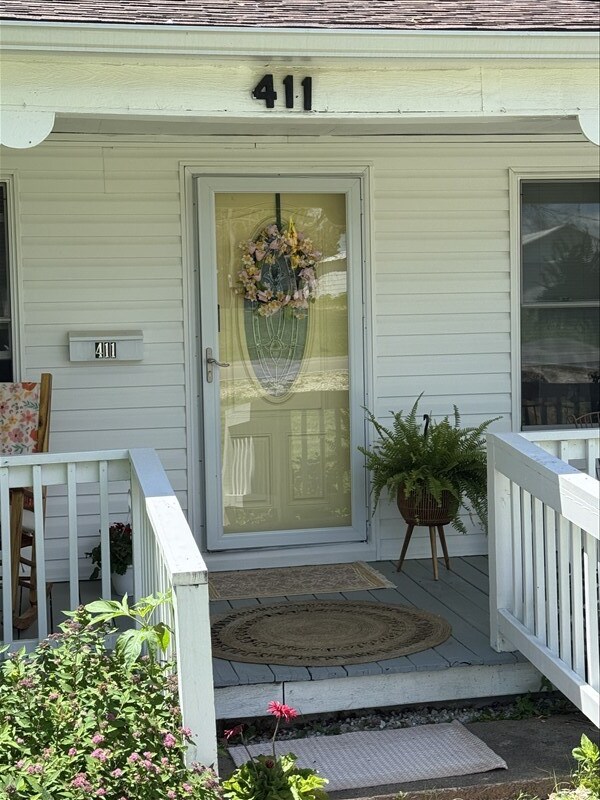 411 S Macon St, Bevier, MO 63532 - property entrance featuring a porch and roof with shingles