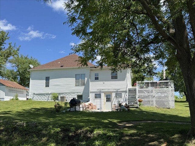 411 S Macon St, Bevier, MO 63532 - rear view of house with a lawn, stairway, and a wooden deck