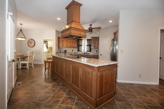 2110 Woodcrest Dr, Chillicothe, MO 64601 - kitchen with baseboards, ceiling fan, decorative backsplash, light stone counters, and black electric stovetop