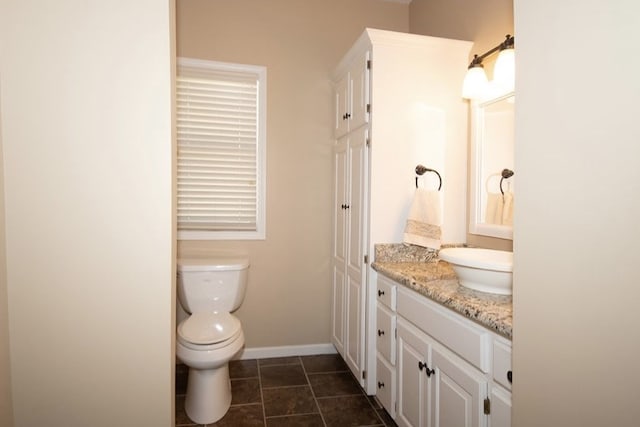 2110 Woodcrest Dr, Chillicothe, MO 64601 - bathroom with vanity, toilet, baseboards, and tile patterned floors