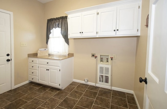 2110 Woodcrest Dr, Chillicothe, MO 64601 - laundry room featuring cabinet space, hookup for an electric dryer, baseboards, and hookup for a washing machine
