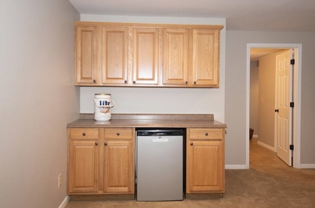 2110 Woodcrest Dr, Chillicothe, MO 64601 - kitchen with dishwashing machine, light carpet, baseboards, and light brown cabinets