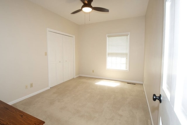 2110 Woodcrest Dr, Chillicothe, MO 64601 - unfurnished bedroom featuring light colored carpet, baseboards, a closet, and a ceiling fan