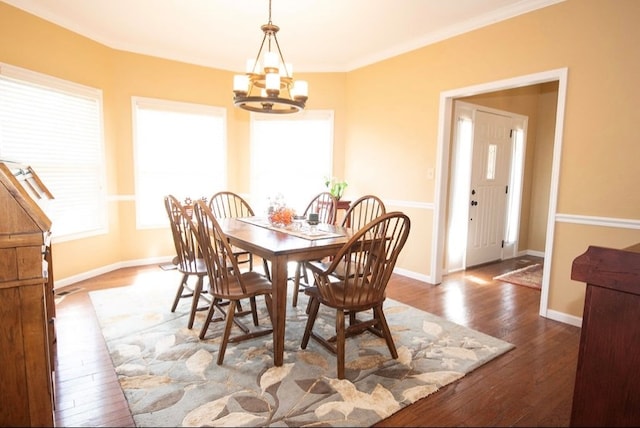 2110 Woodcrest Dr, Chillicothe, MO 64601 - dining area featuring a chandelier, hardwood / wood-style floors, baseboards, and ornamental molding