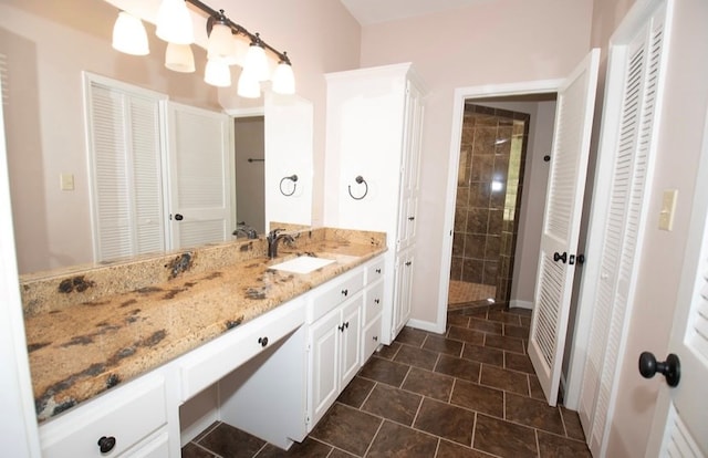 2110 Woodcrest Dr, Chillicothe, MO 64601 - bathroom featuring a closet, vanity, a tile shower, and baseboards