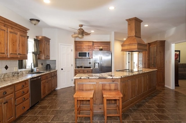 2110 Woodcrest Dr, Chillicothe, MO 64601 - kitchen featuring appliances with stainless steel finishes, a sink, island range hood, backsplash, and a ceiling fan