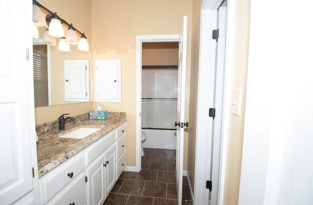 2110 Woodcrest Dr, Chillicothe, MO 64601 - bathroom featuring vanity, toilet, baseboards, tile patterned flooring, and bathtub / shower combination