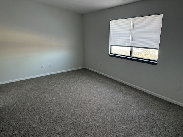 706 Woodwinds Ct, Kirksville, MO 63501 - spare room with baseboards and dark colored carpet
