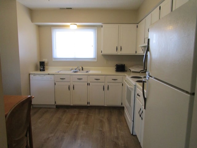 102 Woodwinds Ct, Kirksville, MO 63501 - kitchen featuring wood finished floors, white appliances, a sink, and white cabinetry