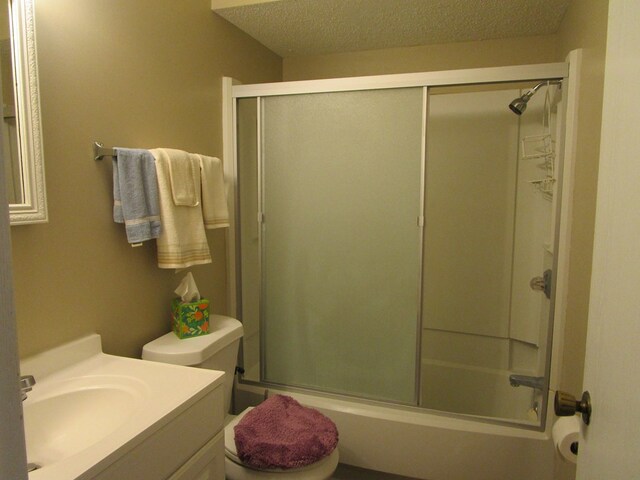 102 Woodwinds Ct, Kirksville, MO 63501 - full bath featuring combined bath / shower with glass door, toilet, a textured ceiling, and vanity