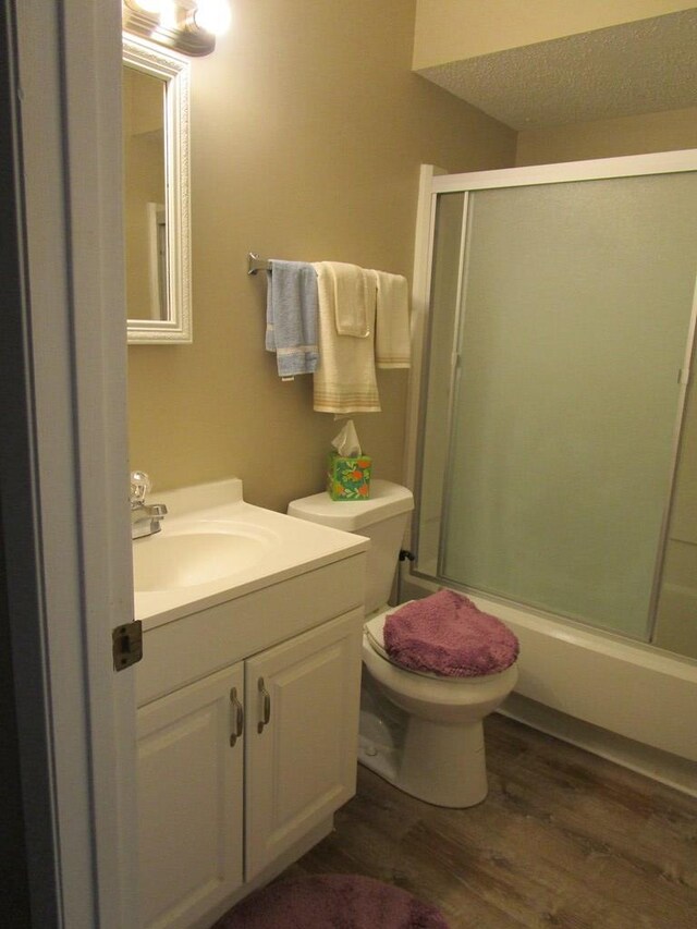 102 Woodwinds Ct, Kirksville, MO 63501 - full bathroom featuring toilet, a textured ceiling, wood finished floors, and vanity