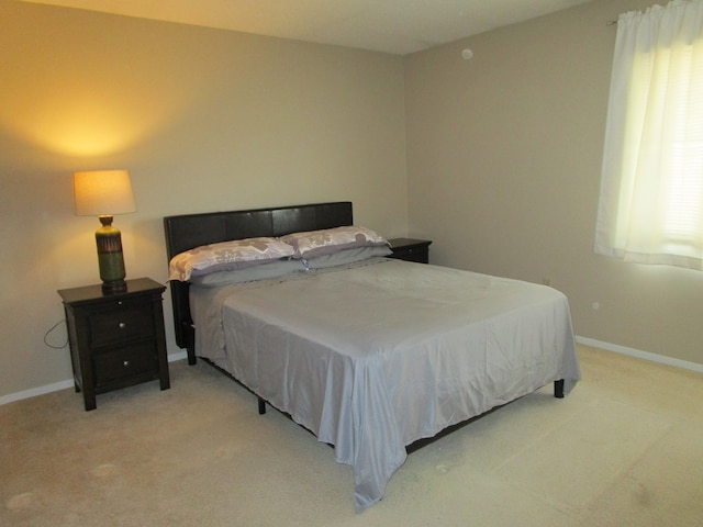 102 Woodwinds Ct, Kirksville, MO 63501 - bedroom featuring multiple windows, baseboards, and light colored carpet