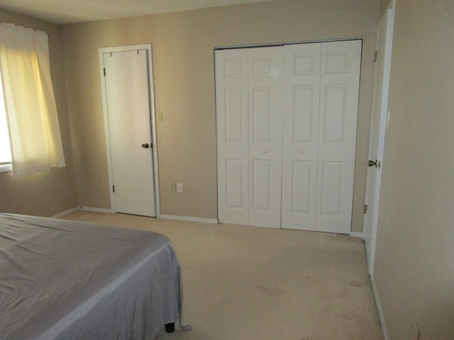 102 Woodwinds Ct, Kirksville, MO 63501 - bedroom with baseboards, a closet, and light colored carpet