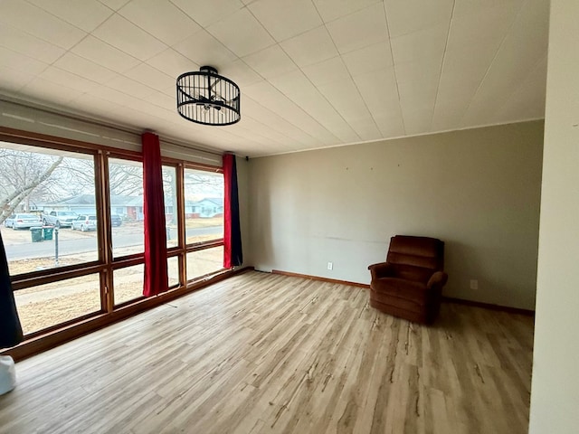 unfurnished room featuring light wood-type flooring and baseboards